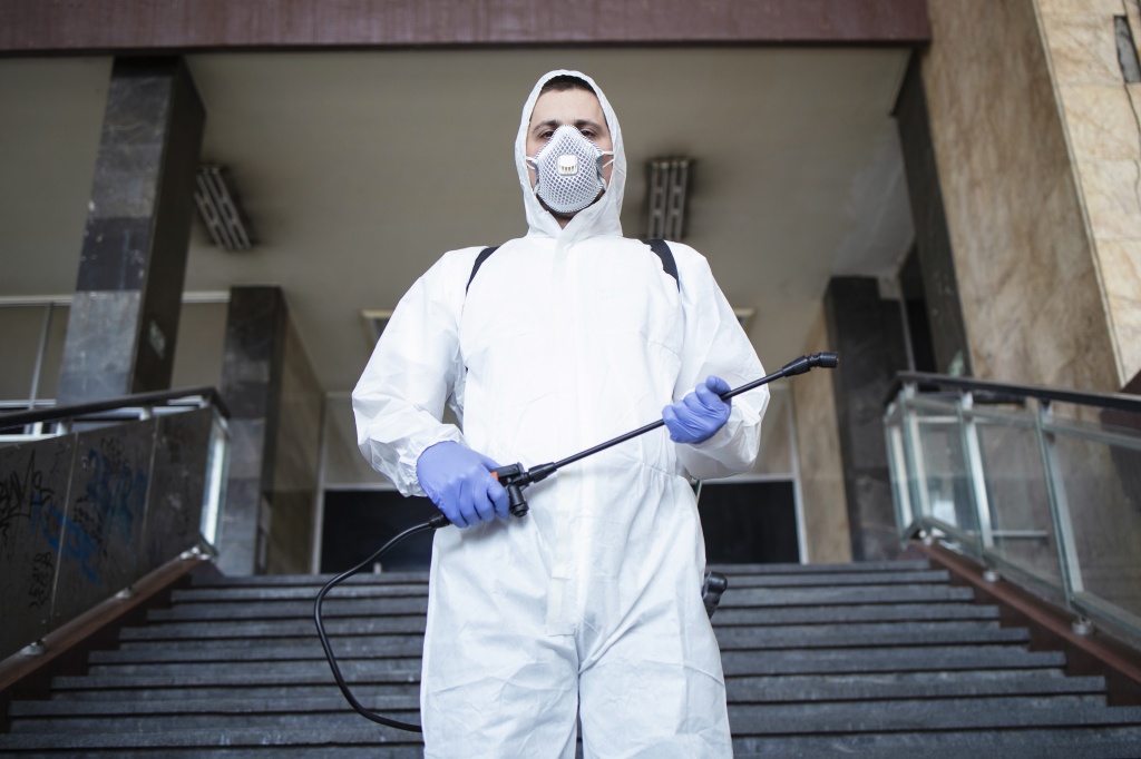 portrait-of-man-in-white-protection-suit-with-sprayer-tank-ready-for-a-fight-against-corona-virus.jpg